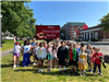 Falls school kids in front of digital sign