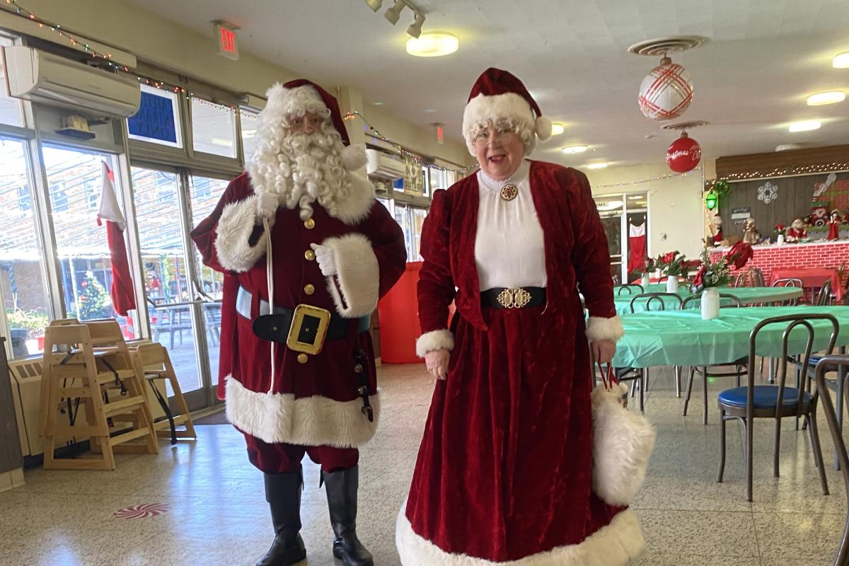 Lady standing next to Santa.