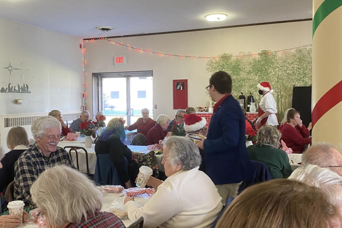 People laughing sitting at tables.