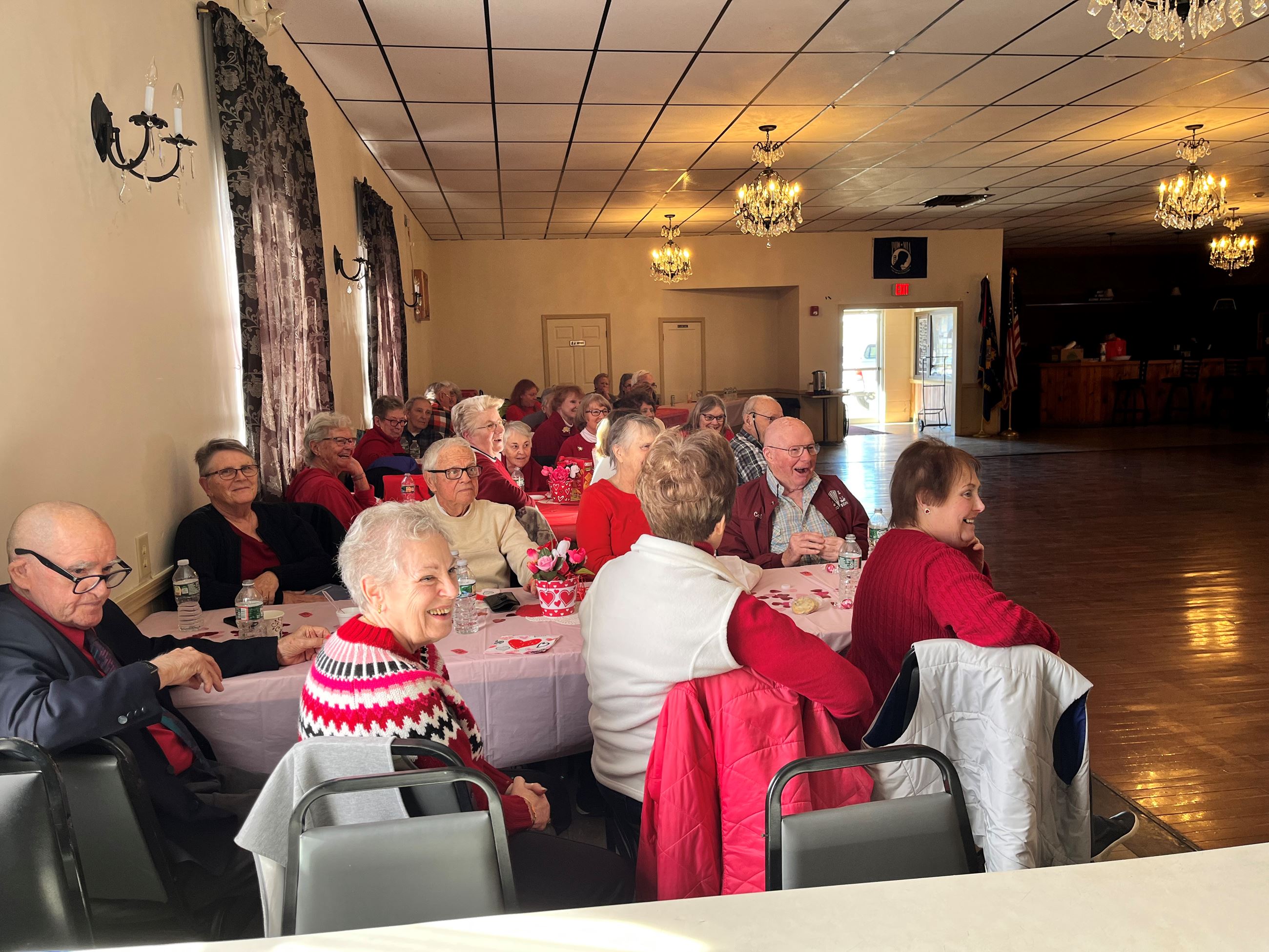 People laughing gathered at tables