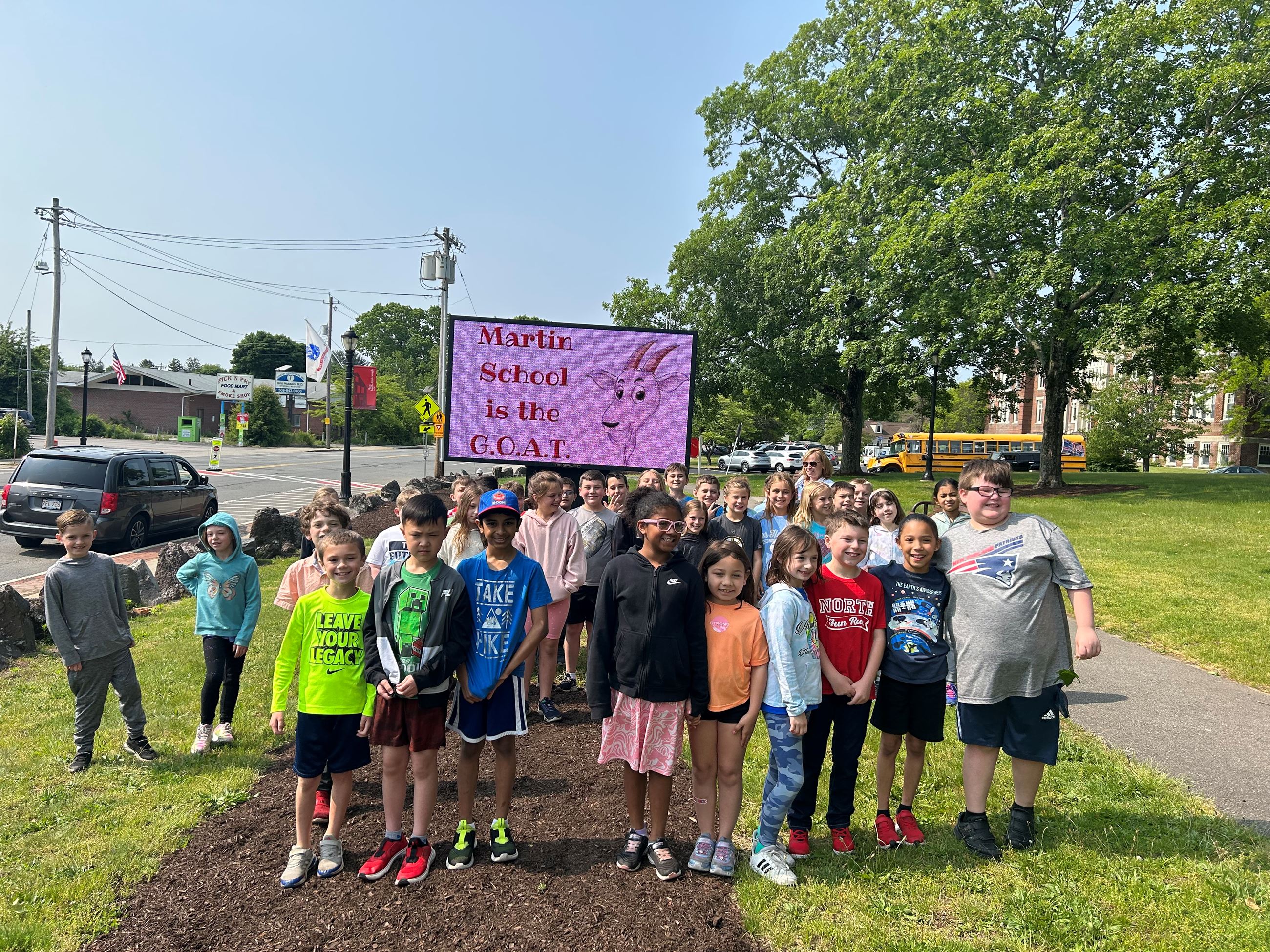 Martin School class in front of digital sign