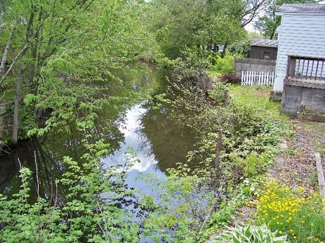Flooded River next to House